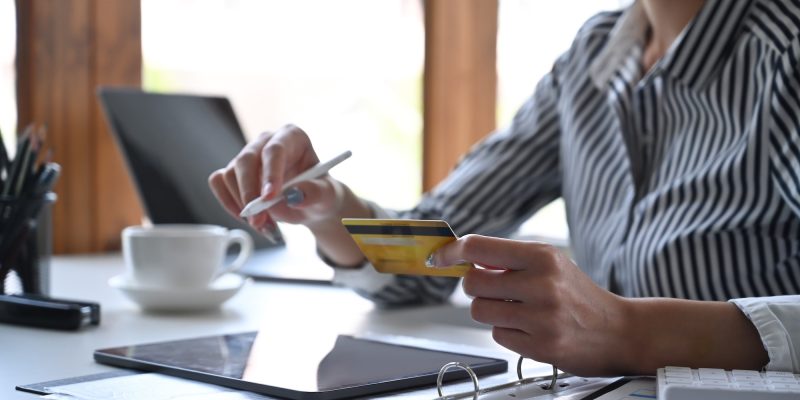 young-woman-holding-credit-card-and-making-online-banking-on-digital-tablet-.jpg